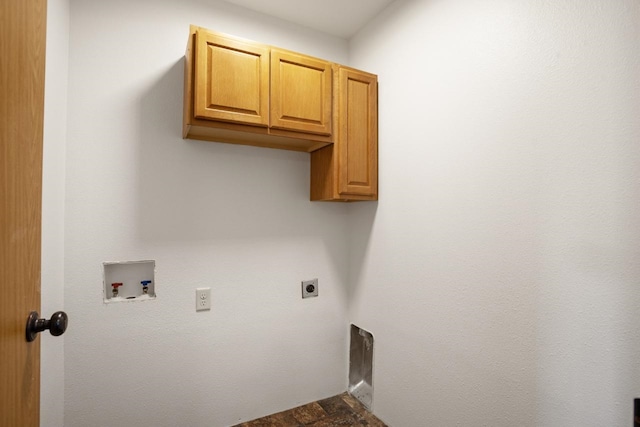 washroom with hookup for an electric dryer, hookup for a washing machine, and cabinet space