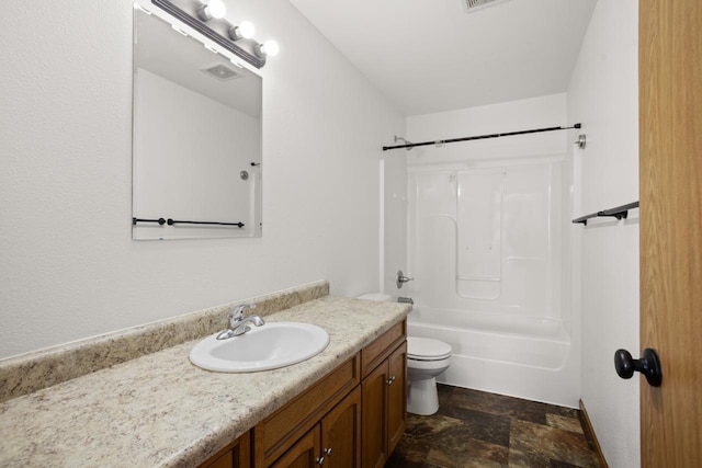 full bathroom with vanity, visible vents, toilet,  shower combination, and stone finish flooring