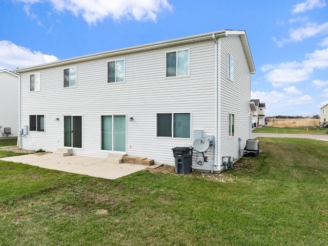 rear view of property featuring a patio, central air condition unit, and a yard