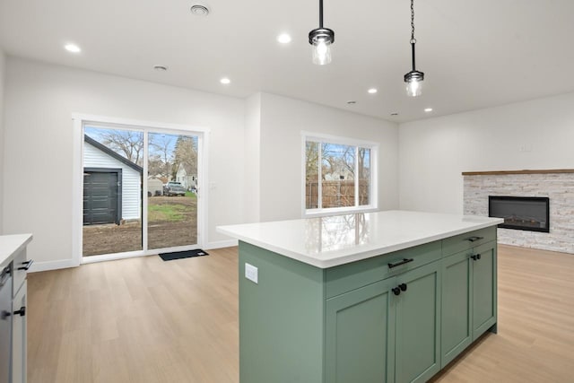 kitchen featuring light wood-style floors, plenty of natural light, and green cabinets