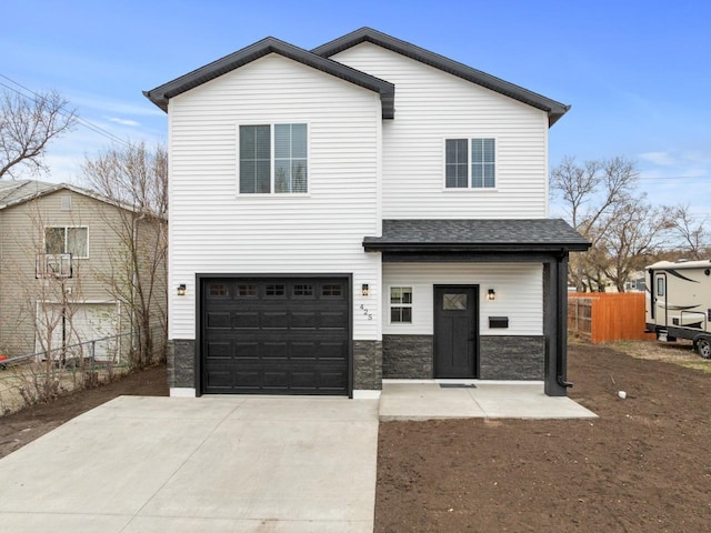 view of front of home with driveway, roof with shingles, a garage, fence, and stone siding