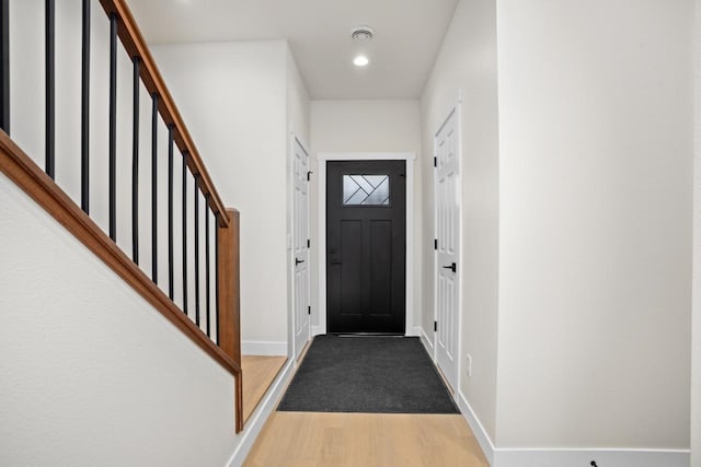 doorway to outside featuring stairway, baseboards, recessed lighting, and wood finished floors