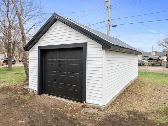 detached garage featuring fence