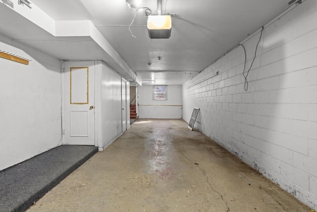 basement featuring stairs and concrete block wall