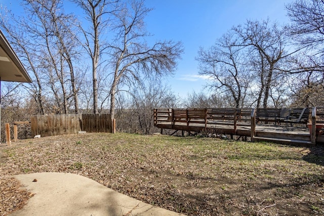 view of yard with a deck and fence