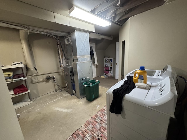 unfinished basement with washing machine and clothes dryer and heating unit