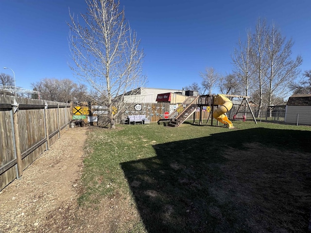 view of yard with a fenced backyard and a playground