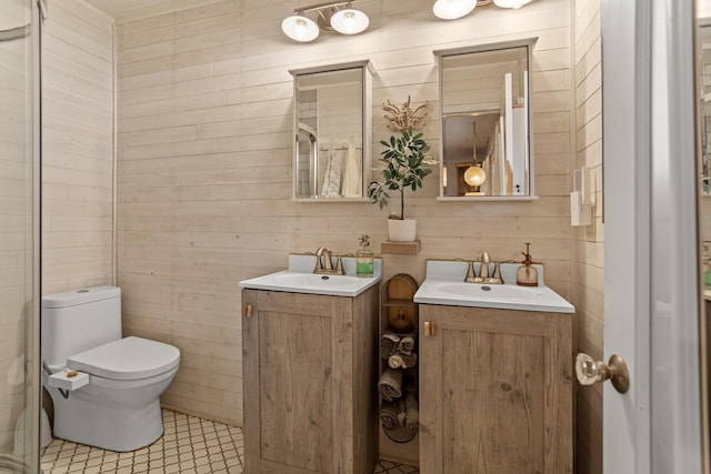 9500 135th Ave, Sawyer, ND 58781 - bathroom featuring wooden walls, toilet, two vanities, and a sink