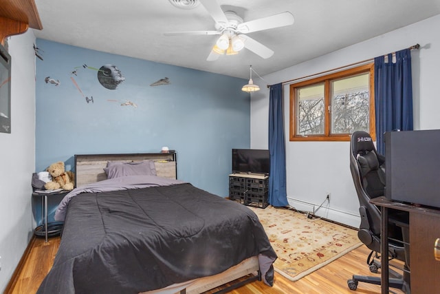 9500 135th Ave, Sawyer, ND 58781 - bedroom with ceiling fan and wood finished floors