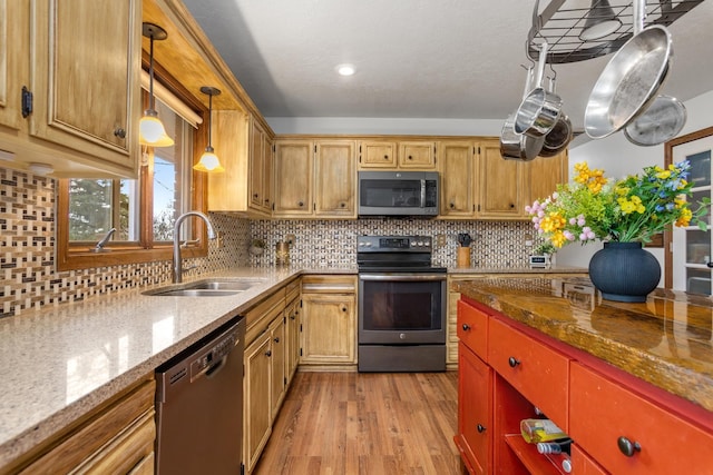 9500 135th Ave, Sawyer, ND 58781 - kitchen featuring appliances with stainless steel finishes, light stone counters, a sink, light wood-style flooring, and tasteful backsplash