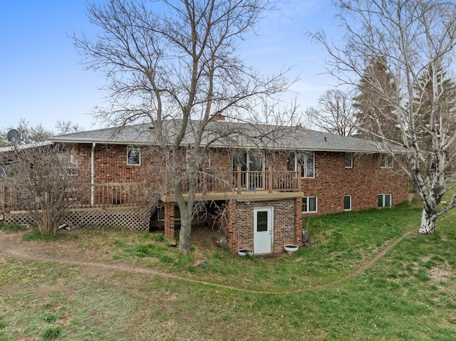 9500 135th Ave, Sawyer, ND 58781 - rear view of house featuring brick siding, a chimney, a yard, and a deck