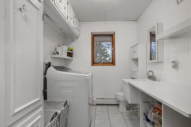 9500 135th Ave, Sawyer, ND 58781 - bathroom featuring washing machine and clothes dryer, toilet, a baseboard heating unit, and marble finish floor