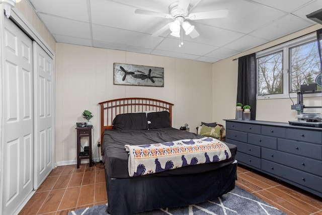 9500 135th Ave, Sawyer, ND 58781 - tiled bedroom featuring a closet, a ceiling fan, and a drop ceiling