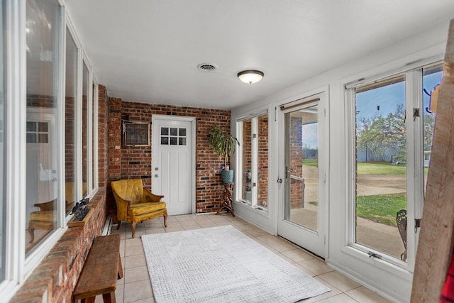 9500 135th Ave, Sawyer, ND 58781 - sunroom with brick wall, visible vents, french doors, and tile patterned floors