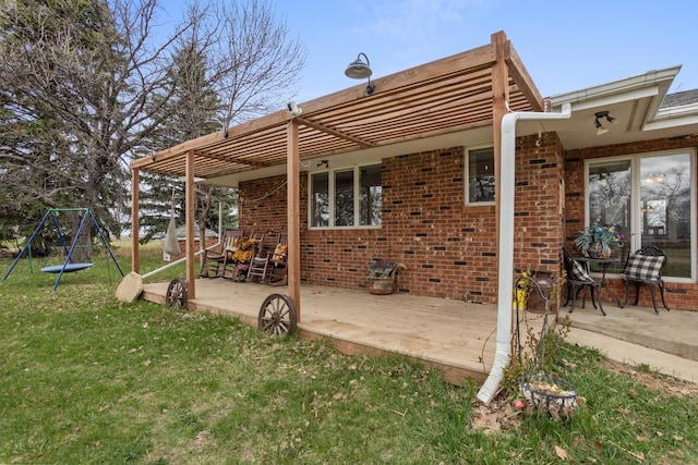 9500 135th Ave, Sawyer, ND 58781 - rear view of house with a lawn, brick siding, a patio area, and a deck