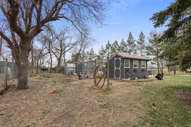 9500 135th Ave, Sawyer, ND 58781 - view of yard featuring exterior structure, fence, and an outbuilding
