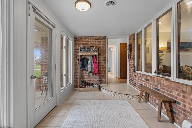 9500 135th Ave, Sawyer, ND 58781 - hallway with light tile patterned floors, brick wall, and visible vents