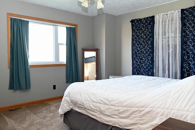 bedroom with baseboards, carpet, and visible vents