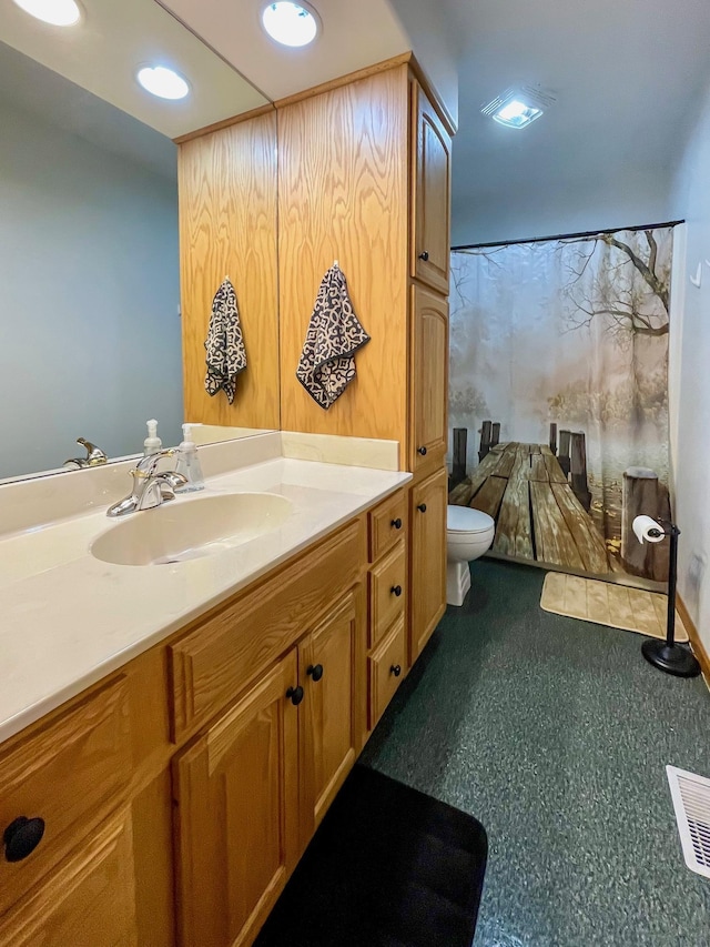 bathroom featuring vanity, a shower with curtain, toilet, and visible vents