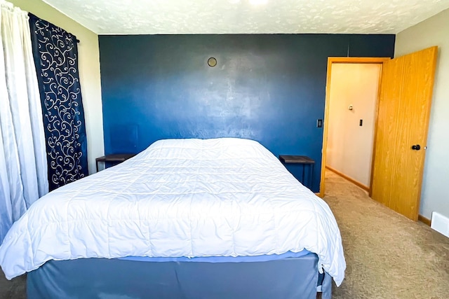 bedroom featuring baseboards and carpet