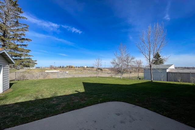 view of yard featuring fence and a patio area