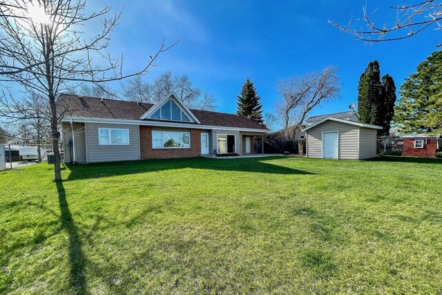 view of front of property with a storage shed, fence, and a front lawn