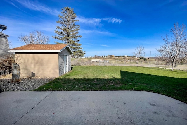 view of yard with a storage unit, an outdoor structure, and a patio area