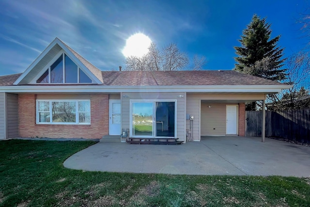 ranch-style house featuring brick siding, fence, a front yard, and entry steps