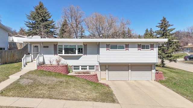 view of front of property featuring an attached garage, a front lawn, fence, and concrete driveway