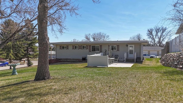 rear view of house featuring a lawn, a patio, and entry steps