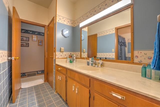 full bath with tile patterned floors and vanity