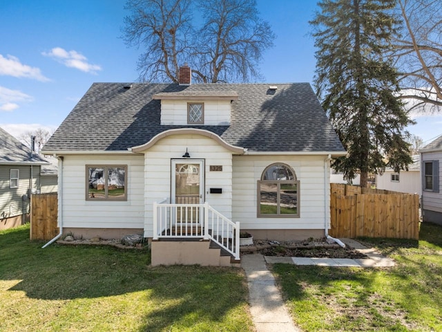 bungalow-style home featuring a chimney, a front lawn, a shingled roof, and fence