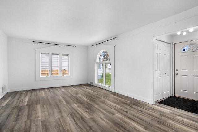 entryway featuring wood finished floors and baseboards
