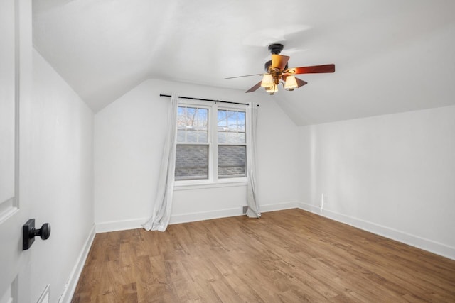 additional living space featuring vaulted ceiling, ceiling fan, and wood finished floors