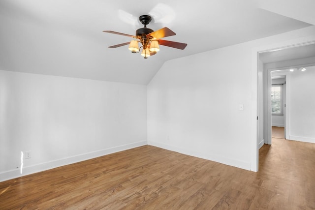 bonus room with a ceiling fan, lofted ceiling, baseboards, and wood finished floors