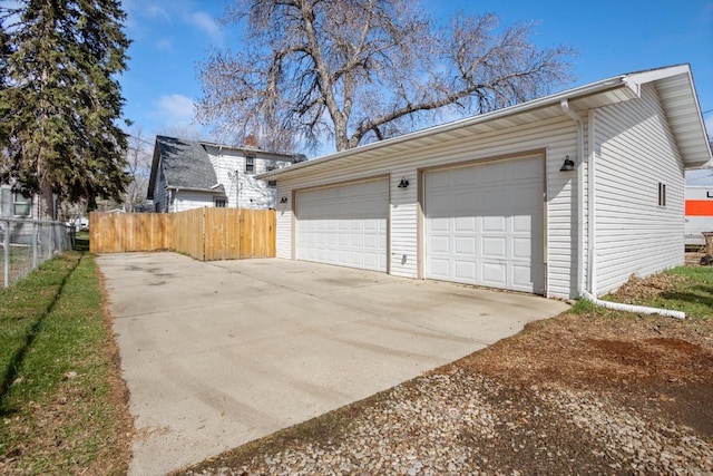 detached garage featuring fence
