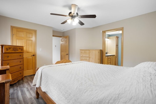 bedroom with ceiling fan, a sink, and wood finished floors