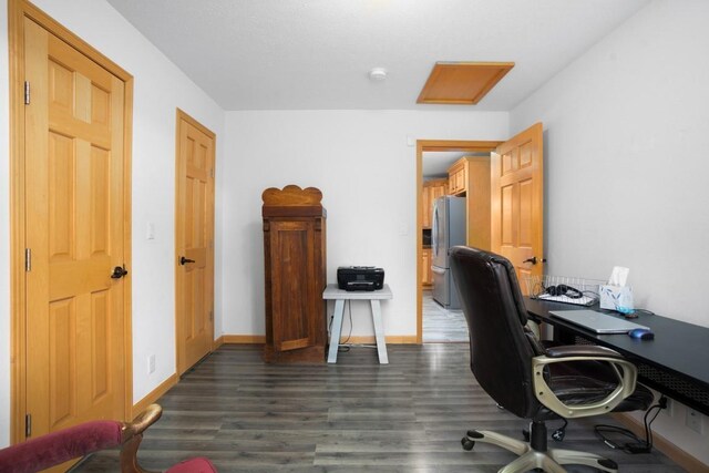 home office featuring baseboards and dark wood finished floors