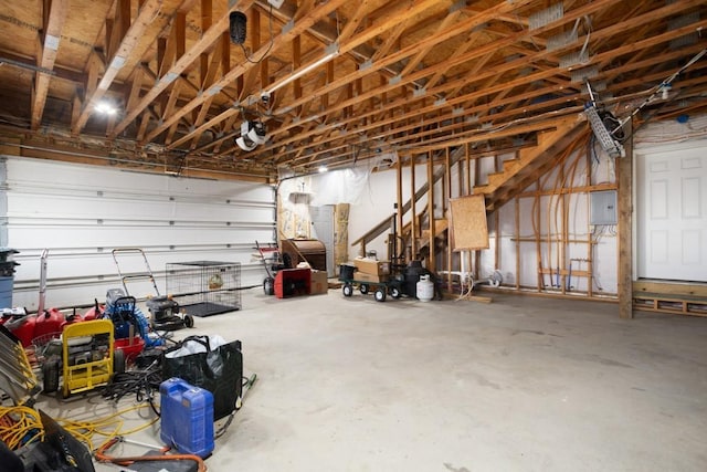 garage with electric panel and a garage door opener