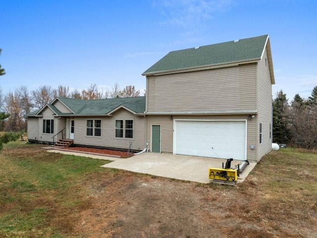 view of front of home with a front yard, a garage, and driveway