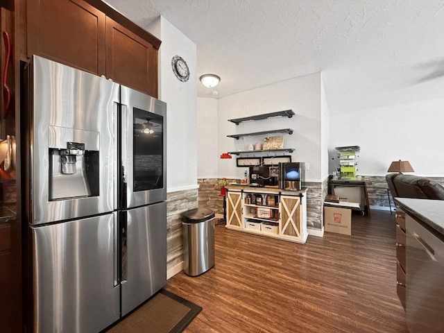 4005 Crossing St, Minot, ND 58701 - kitchen with a textured ceiling, wainscoting, open shelves, dark wood-type flooring, and appliances with stainless steel finishes