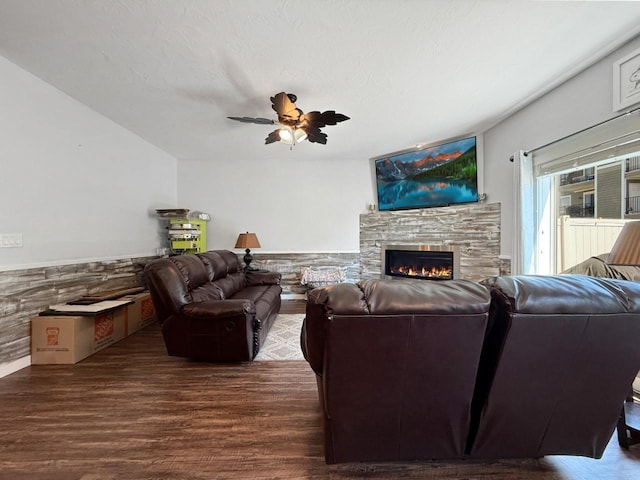 4005 Crossing St, Minot, ND 58701 - living area with wainscoting, wood finished floors, a ceiling fan, and a stone fireplace