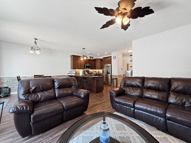 4005 Crossing St, Minot, ND 58701 - living area featuring recessed lighting, dark wood-style floors, and ceiling fan with notable chandelier