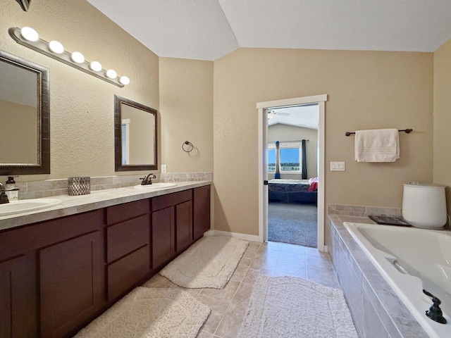 4005 Crossing St, Minot, ND 58701 - ensuite bathroom with a sink, double vanity, lofted ceiling, and tiled bath