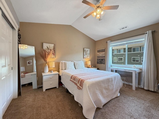 4005 Crossing St, Minot, ND 58701 - bedroom with a closet, carpet floors, visible vents, ceiling fan, and vaulted ceiling