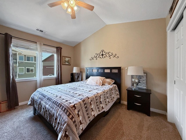 4005 Crossing St, Minot, ND 58701 - carpeted bedroom with a closet, visible vents, vaulted ceiling, ceiling fan, and baseboards