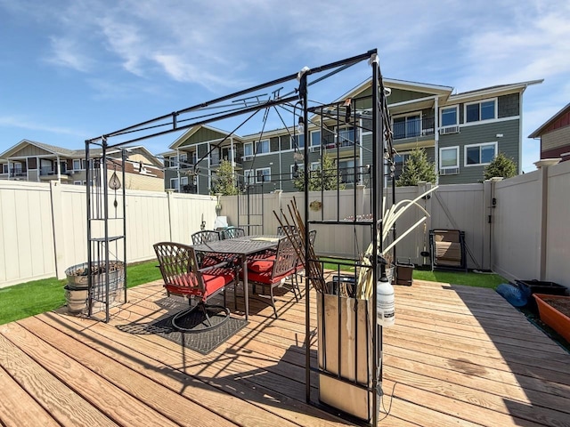 4005 Crossing St, Minot, ND 58701 - wooden terrace with a fenced backyard, outdoor dining space, and a residential view