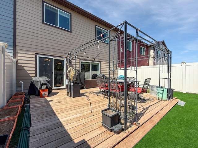 4005 Crossing St, Minot, ND 58701 - wooden deck with outdoor dining space and fence