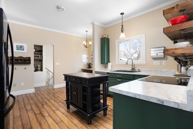 724 3rd Ave, Minot, ND 58703 - kitchen featuring a sink, green cabinetry, wood finished floors, open shelves, and light countertops