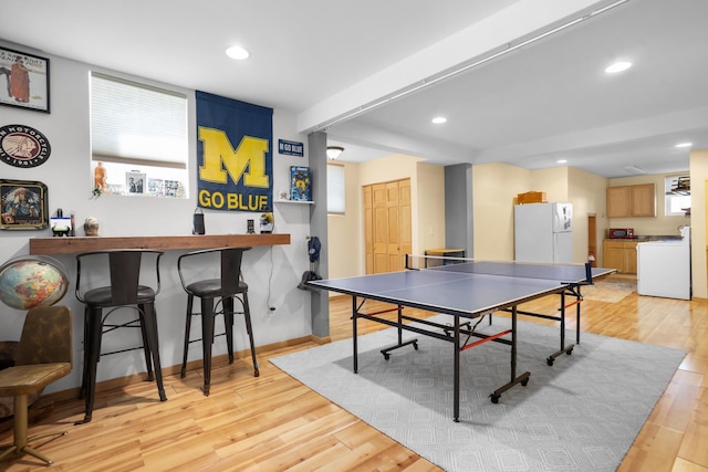 724 3rd Ave, Minot, ND 58703 - game room with a bar, light wood-type flooring, baseboards, washer / dryer, and recessed lighting